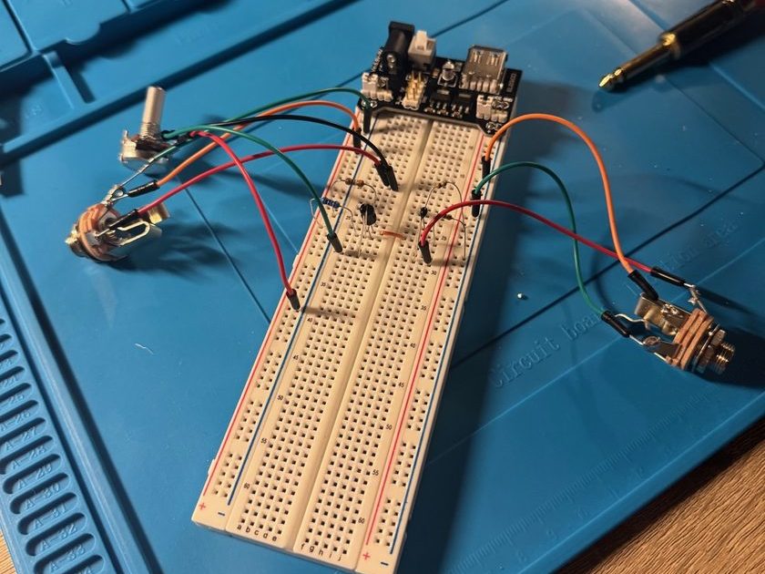 The boost pedal circuit on a breadboard, with the volume potentiometer and both jacks wired off-board and a bench supply feeding the rail
